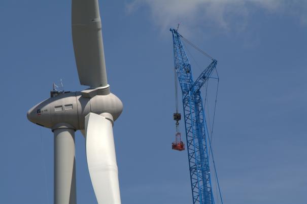 low-angle-view-crane-windmill-against-blue-sky